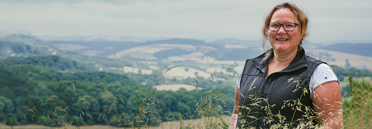 Agrii livestock Advisor in field with hills and landscape background